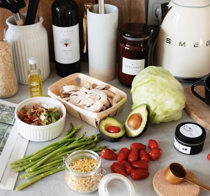 A variety of fresh ingredients and kitchen tools for preparing a healthy meal.